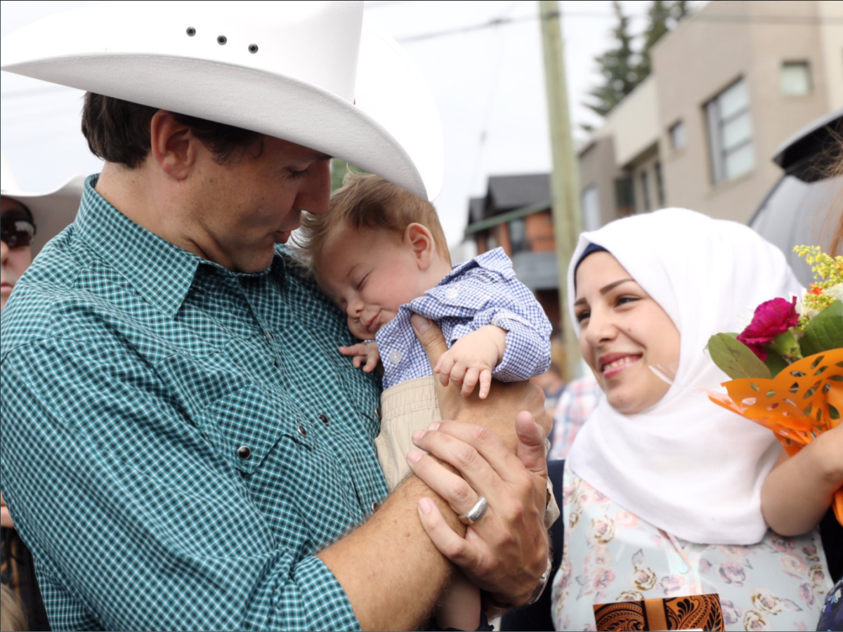 Prime Minister Justin Trudeau holds baby Justin-Trudeau Adam Bilal at the Calgary Stampede on Saturday.