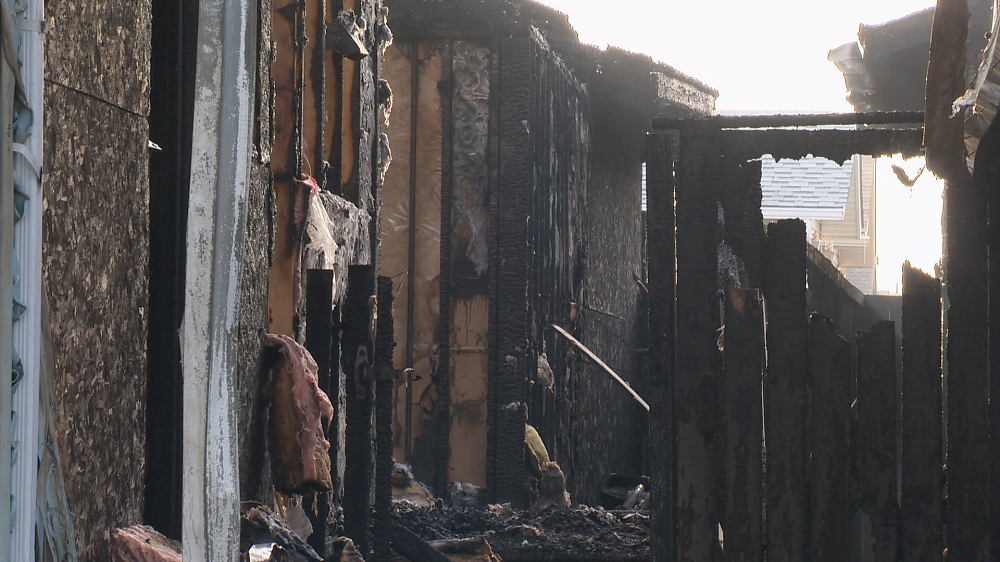 An early morning house fire in northeast Calgary damaged multiple houses and left seven people without a home. 