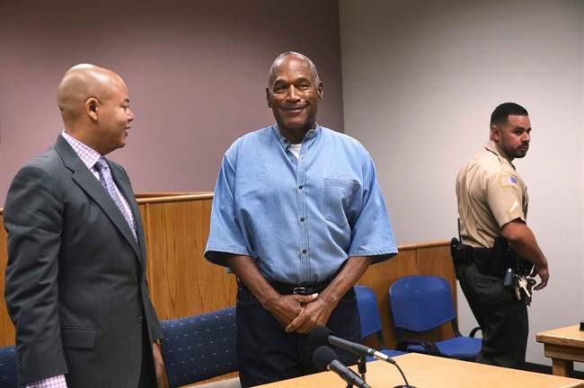 Former NFL football star O.J. Simpson, center, enters for his parole hearing at the Lovelock Correctional Center in Lovelock, Nev., on Thursday, July 20, 2017. 