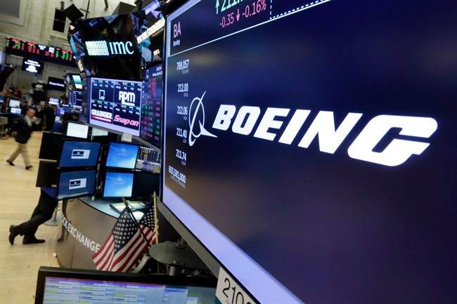 In this Monday, July 24, 2017, photo, the Boeing logo appears above a trading post on the floor of the New York Stock Exchange. The Boeing Co. reports earnings, Wednesday, July 26, 2017. The American-based company has started a PR campaign aimed at reminding Canadians of its contributions to the country's economy. WEdnesday, Oct. 11, 2017.