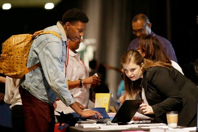 FILE - In this Friday, May 19, 2017, file photo, job seeker Dalvin Jones, left, chats with Valmira Haxhimusa.