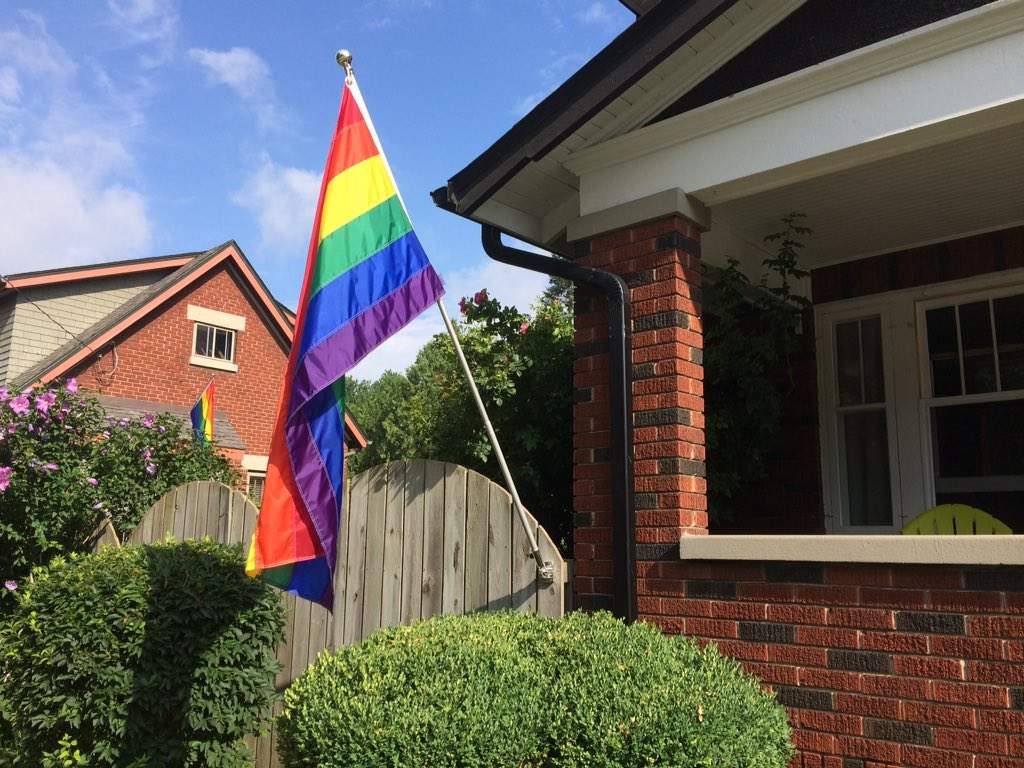 A new flag now flies in front of the Wortley village home. In the background, a pride flag put up by a neighbour in a show of support can be seen.