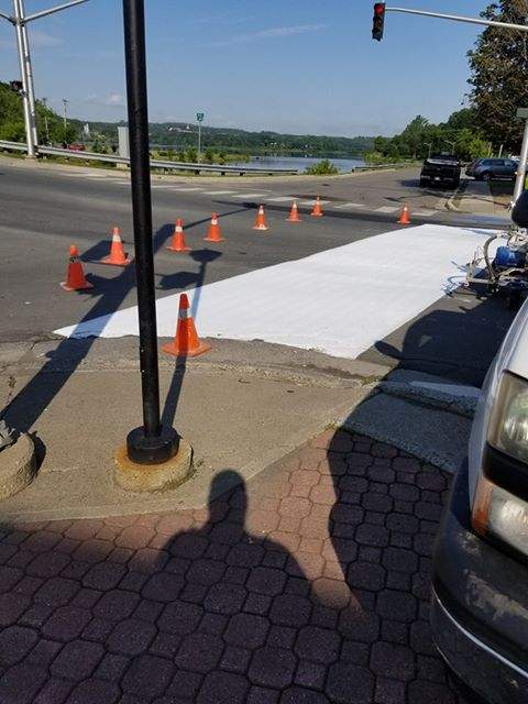 Work starts on repainting the rainbow crosswalk in Woodstock, N.B. after it was vandalized over the weekend.