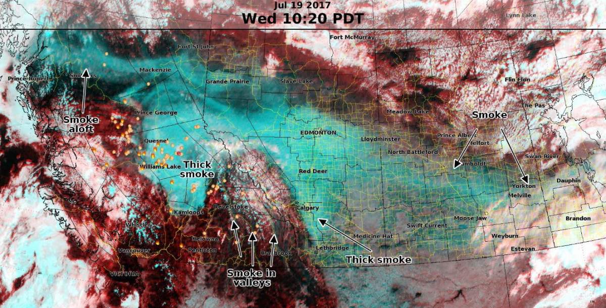 A satellite image from Environment Canada shows smoke drifting through the Rocky Mountains.