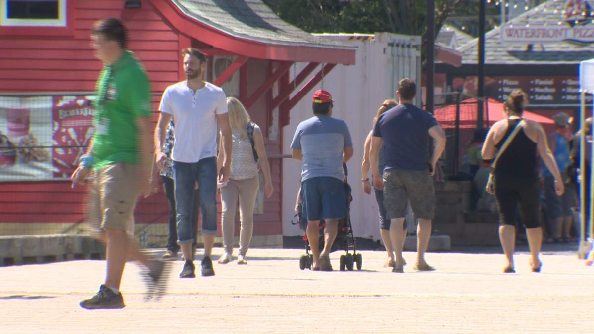 People walk along the Halifax Waterfront on Monday, July 10, 2017. The waterfront has become the third location to be connected to the municipality's free public Wi-Fi service.