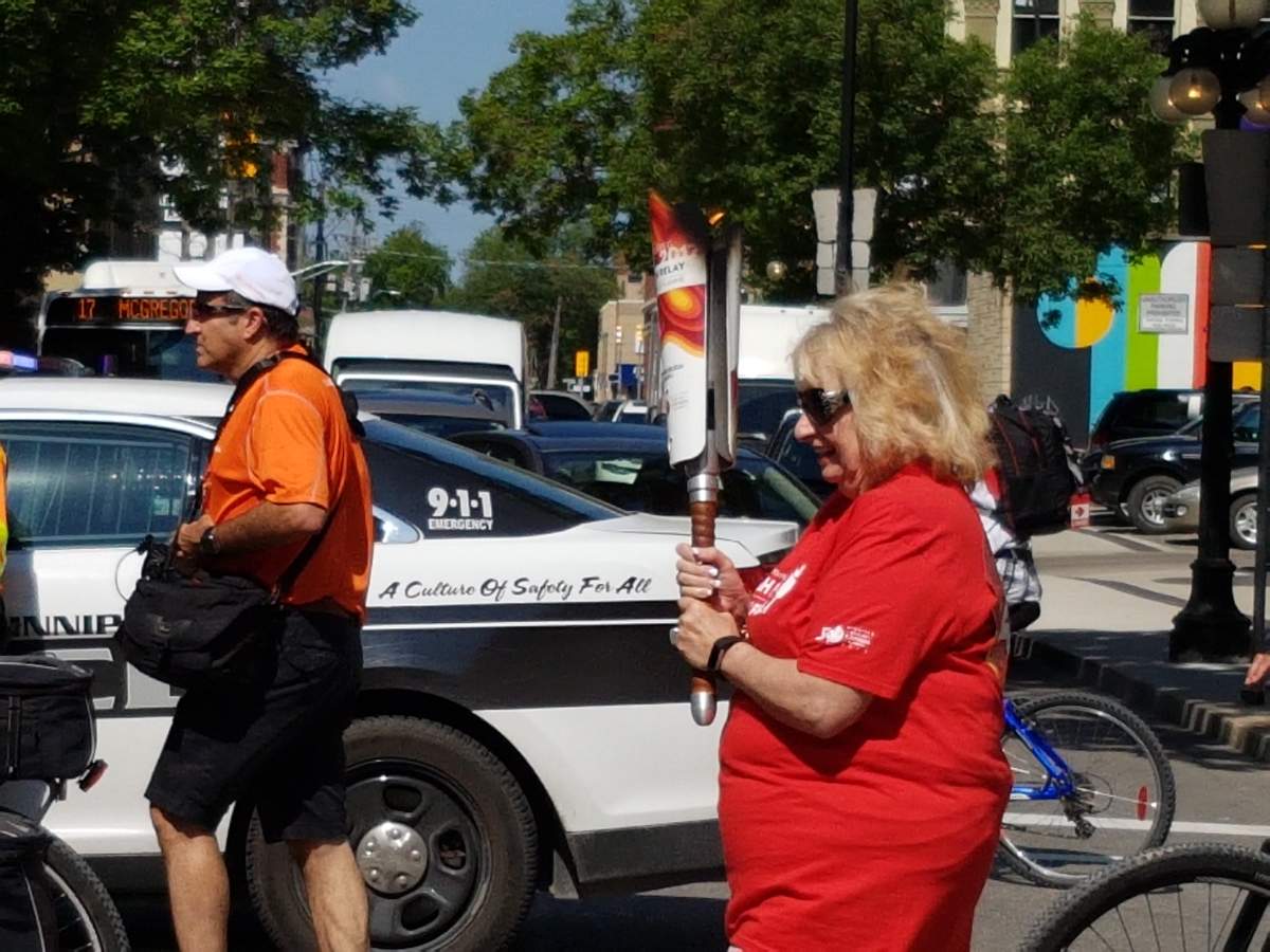 Wilma Derksen with the torch as it reached Winnipeg ahead of the 2017 Canada Summer Games.