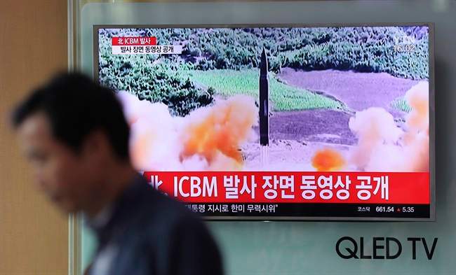 A man walks by a TV screen showing a local news program reporting about North Korea’s missile firing at Seoul Train Station in Seoul, South Korea, Wednesday, July 5, 2017.