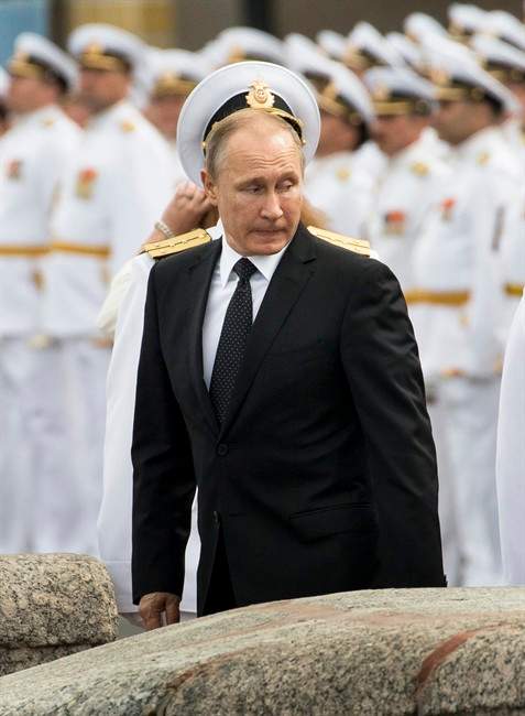 Russian sailors stand in attention as Russian President Vladimir Putin leaves after attending the military parade during the Navy Day celebration in St. Petersburg, Russia, on Sunday, July 30, 2017. 