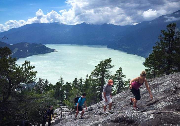 People climb up a rock face towards the first peak on the Stawamus Chief mountain above the waters of Howe Sound in Squamish, B.C., on Saturday, July 2, 2016.