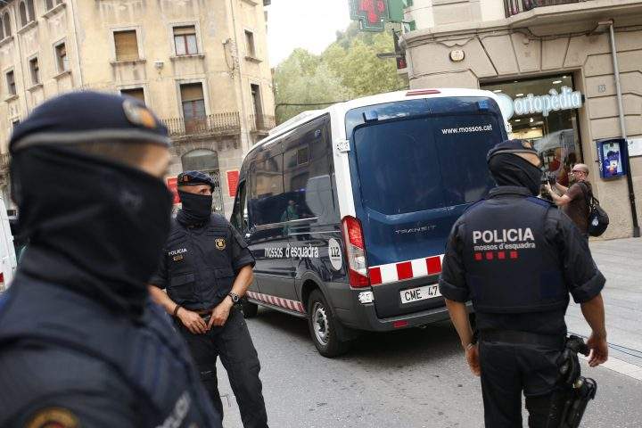 A police van drives away with a detained suspect after a search of a building in Ripoll, north of Barcelona, Spain, Friday, Aug. 18, 2017.