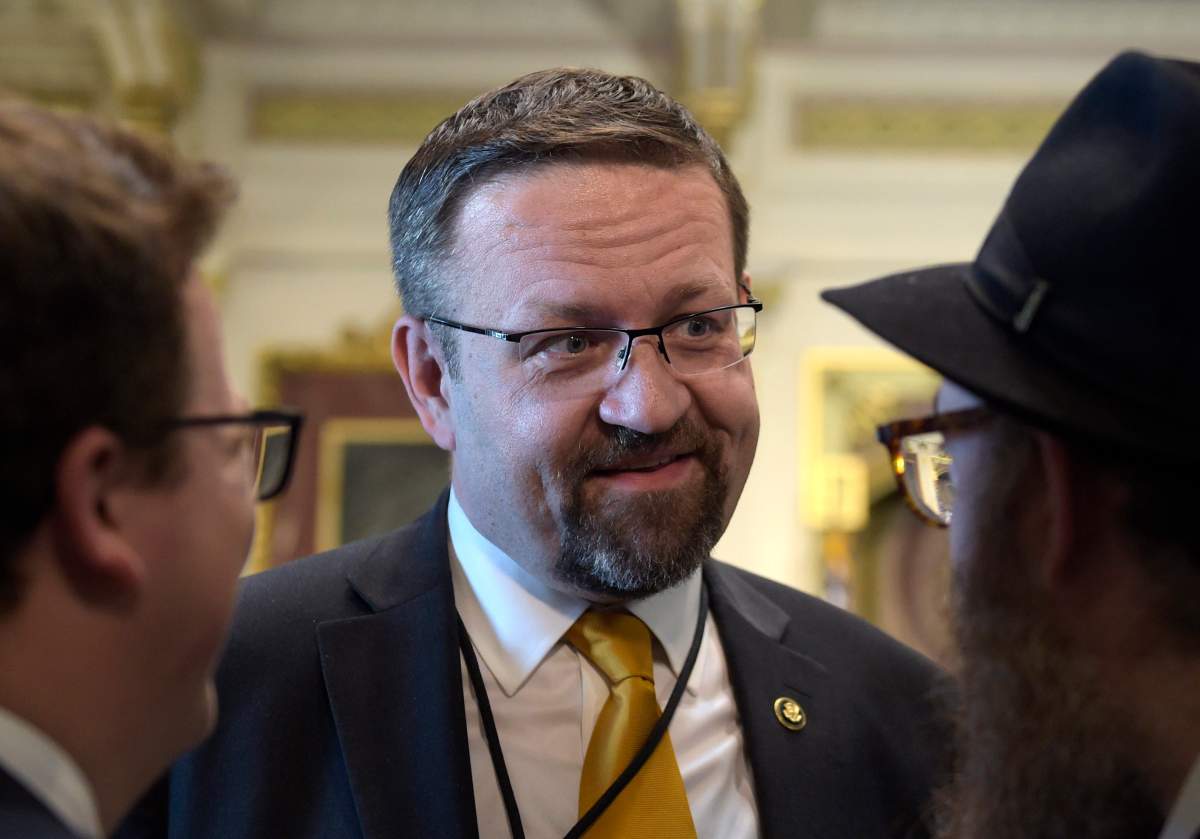 FILE – In this Tuesday, May 2, 2017 file photo, deputy assistant to President Trump, Sebastian Gorka, talks with people in the Treaty Room in the Eisenhower Executive Office Building on the White House complex in Washington during a ceremony commemorating Israeli Independence Day.