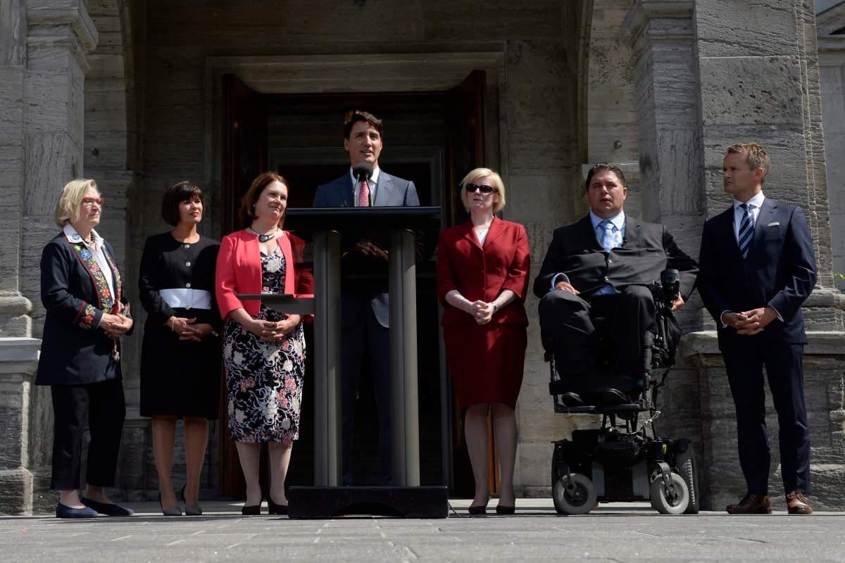 Prime Minister Justin Trudeau stands alongside his newly shuffled cabinet (left to right) Carolyn Bennett, Ginette Petitpas Taylor, Jane Philpott, Carla Qualtrough, Kent Hehr and Seamus O’Regan.