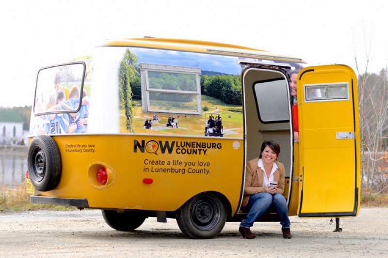 Tina Hennigar sits in the NOW Lunenburg County camper redesigned for the trek across Canada.