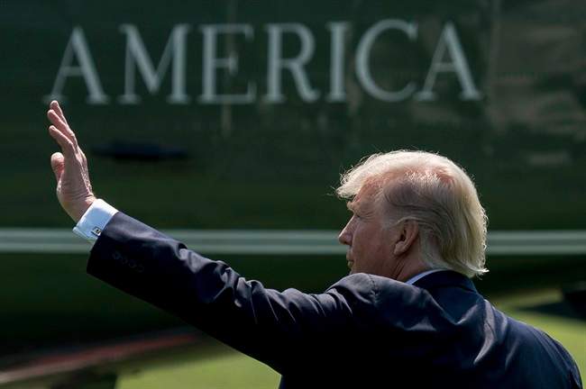 In this Tuesday, Aug. 22, 2017, file photo, President Donald Trump waves as he walks across the South Lawn of the White House in Washington to board Marine One for a short trip to Andrews Air Force Base, Md.
