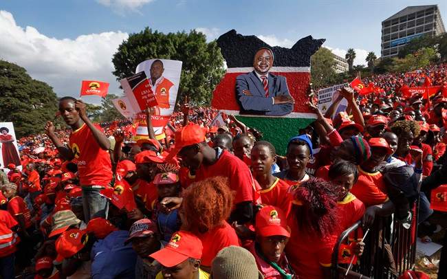 A supporter holds a painting of Kenya’s President Uhuru Kenyatta at an election rally in Uhuru Park in downtown Nairobi, Kenya Friday, Aug. 4, 2017.
