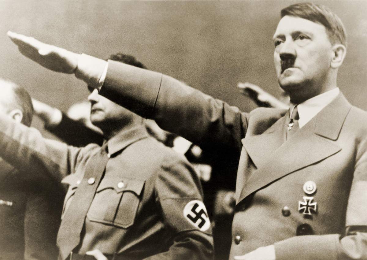 Adolf Hitler, giving Nazi salute. To Hitler's right is Rudolph Hesse. 1939.