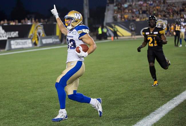 Winnipeg Blue Bombers receiver Julian Feoli-Gudino crosses the goal line to score a touchdown against the Hamilton Tiger-Cats.