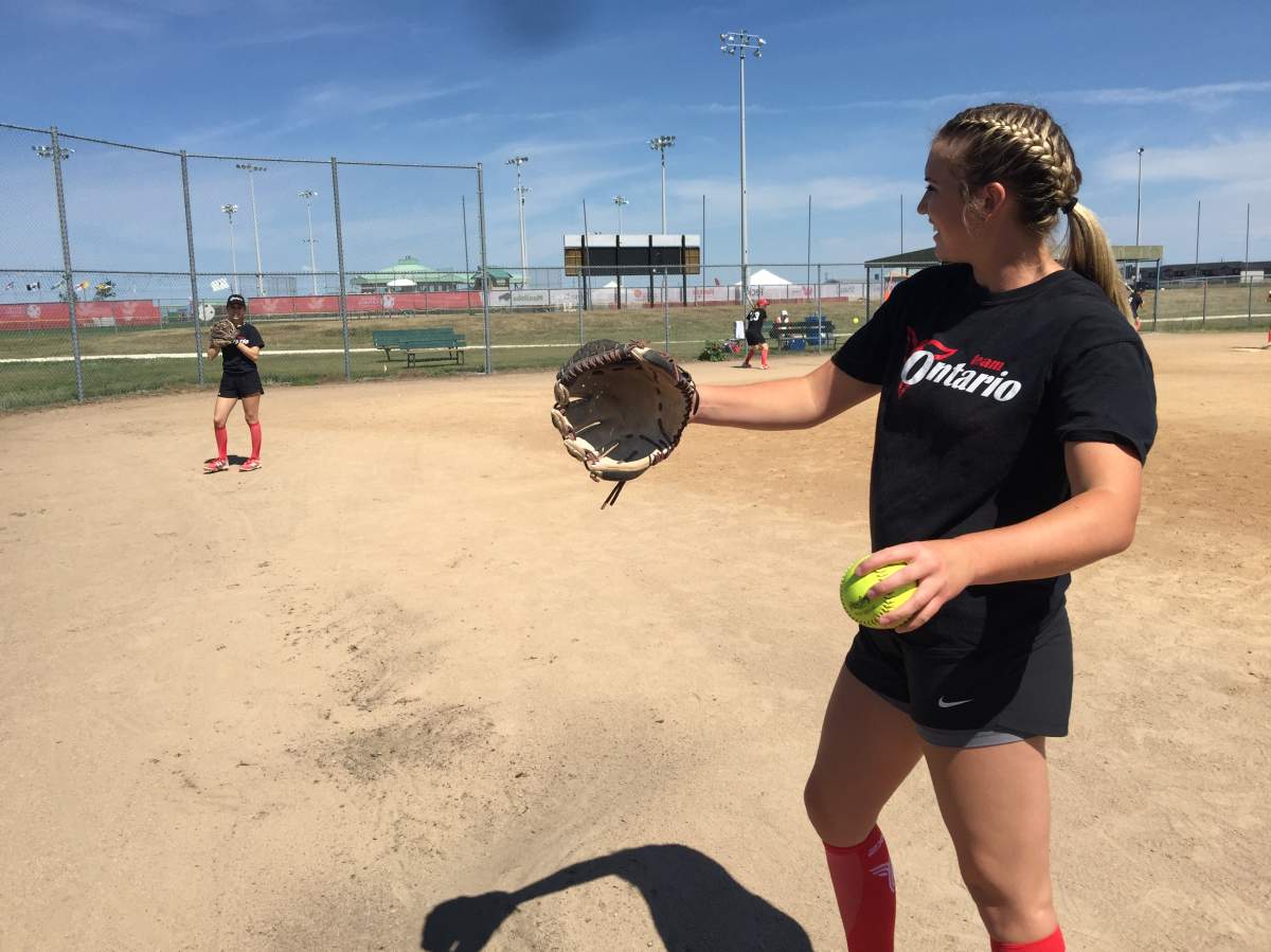 Sierra Bertrand warms up with the Team Ontario softball team, after arriving in Winnipeg Saturday.