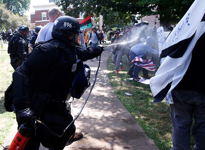 Virginia State Police use pepper spray as they move in to clear a clash between members of white nationalist protesters against a group of counter-protesters in Charlottesville, Virginia, August 12, 2017.