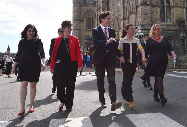 Status of Women Minister Maryam Monsef, left to right, Minister of International Development and La Francophonie Marie-Claude Bibeau, Prime Minister Justin Trudeau, Sophie Gregoire Trudeau and Women Deliver President and CEO Katja Iversen arrive at an event in Ottawa on Tuesday, June 13, 2017. The Liberal government is thinking about using its massive purchasing power to support women in business. 