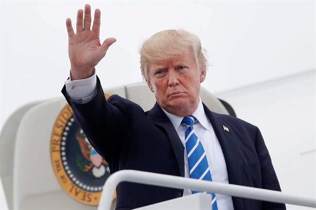 President Donald Trump waves as he boards Air Force One at Hagerstown Regional Airport in Hagerstown, Md., Friday, Aug. 18, 2017. 