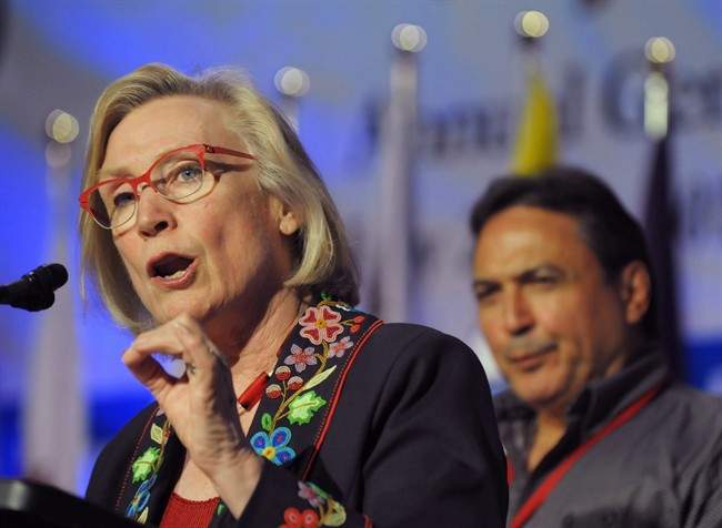 Minister of Indigenous and Northern Affairs, Carolyn Bennett speaks as AFN National Chief Perry Bellegarde looks on at the Assembly of First Nations annual general meeting in Regina, Sask., Tuesday July 25, 2017. Bennett says she's troubled by reports of Indigenous women in and around Saskatoon being coerced into tubal ligation procedures.
