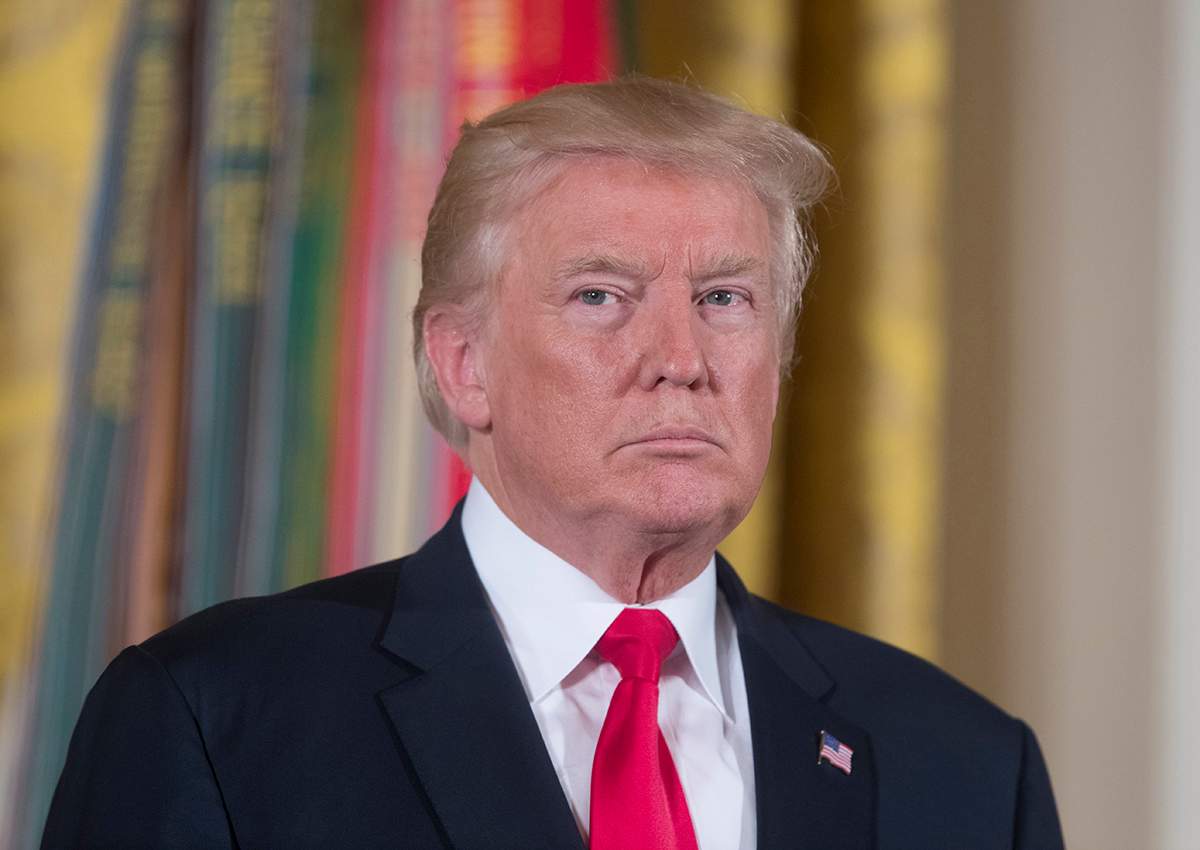 Donald Trump listens to the reading of the citation before awarding the Medal of Honor to US Army medic and Vietnam War veteran James McCloughan (not pictured), during a ceremony in the East Room of the White House.
