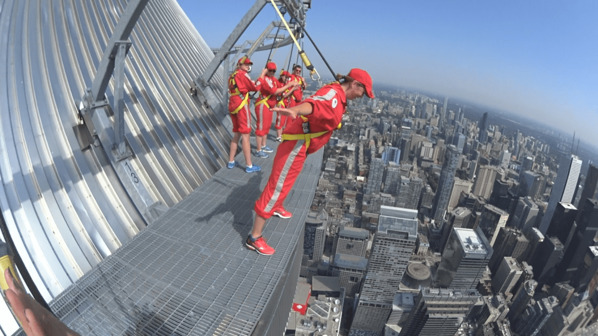 She's not enjoying this one! Global's Kim Sullivan walks on the edge of the CN Tower in Toronto, Monday, July 31, 2017.