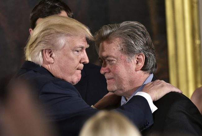 U.S. President Donald Trump embraces Stephen Bannon during the swearing-in of senior staff in the White House on Jan. 22, 2017, in Washington, D.C.