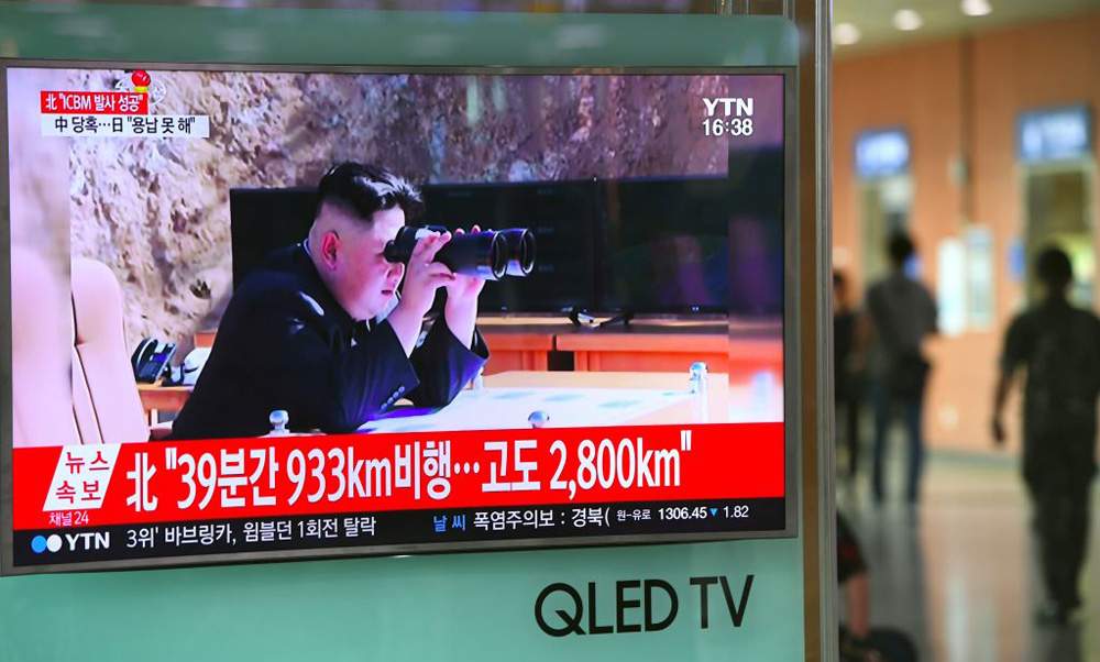A television screen  at a railway station in Seoul shows a picture of North Korean leader Kim Jong-Un watching the country's test launch of an intercontinental ballistic missile.