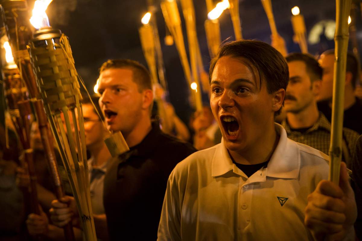 Neo Nazis, Alt-Right, and White Supremacists encircle and chant at counter protestors at the base of a statue of Thomas Jefferson after marching through the University of Virginia campus with torches in Charlottesville, Va., USA on August 11, 2017.
