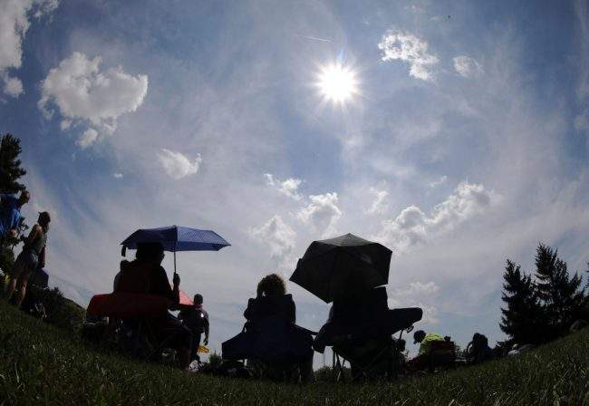 People arrive to Thoroughbred Park in downtown Lexington, Ky. to watch the solar eclipse, Aug. 21, 2017.