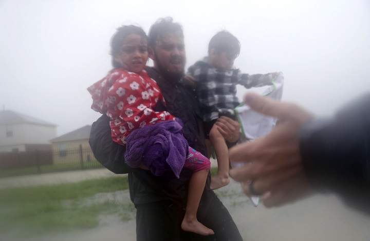 HOUSTON, TX – AUGUST 28: Rescuers help a man and children from flooding from Hurricane Harvey on August 28, 2017 in Houston, Texas. Harvey, which made landfall north of Corpus Christi late Friday evening, is expected to dump upwards to 40 inches of rain in Texas over the next couple of days.