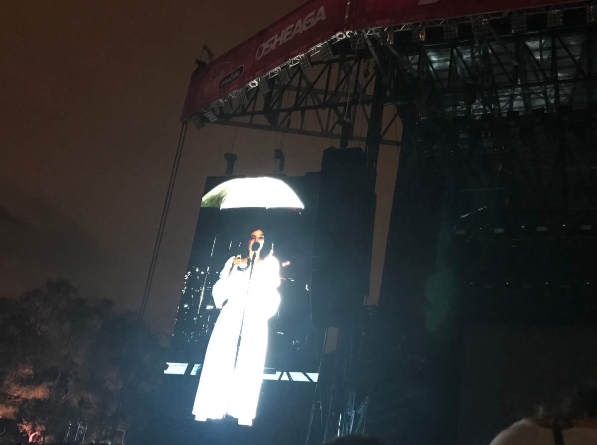 Lorde sings holding an umbrella at the 2017 Osheaga music and art festival.
