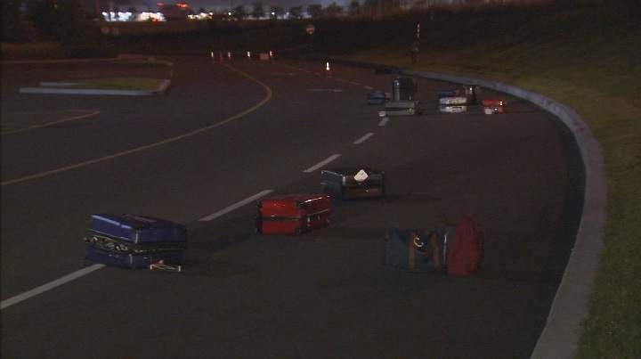 Suitcases filled with stolen goods litter the roadway leading out of the parking lot at the Carrefour Laval mall. Saturday, Aug. 19, 2017.