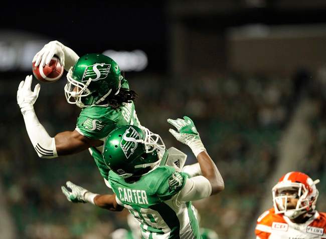 Saskatchewan Roughriders defensive back Ed Gainey outleaps teammate Duron Carter to record his fourth interception during second half CFL action against the B.C. Lions, in Regina on Sunday, August 13, 2017. Gainey and quarterback Kevin Glenn and Edmonton quarterback Mike Reilly are the CFL's top performers for Week 8.