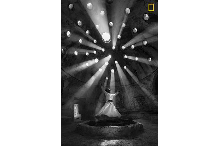 First place winner, People: Beams of light filter through a historic building in Konya, Turkey, where a whirling dervish performs an ecstatic dance.