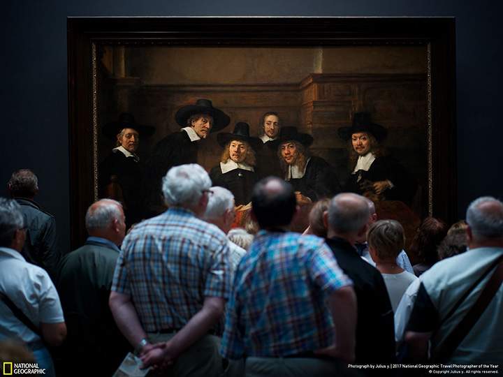 Second place winner, People: A crowd of spectators stands in front of Rembrandt’s masterpiece, Syndics of the Drapers’ Guild, at Rijksmuseum in Amsterdam.