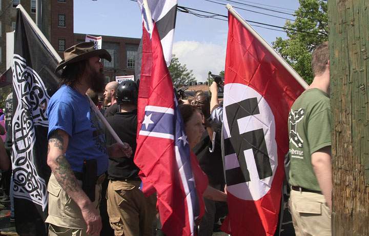 Demonstrators carry confederate and Nazi flags