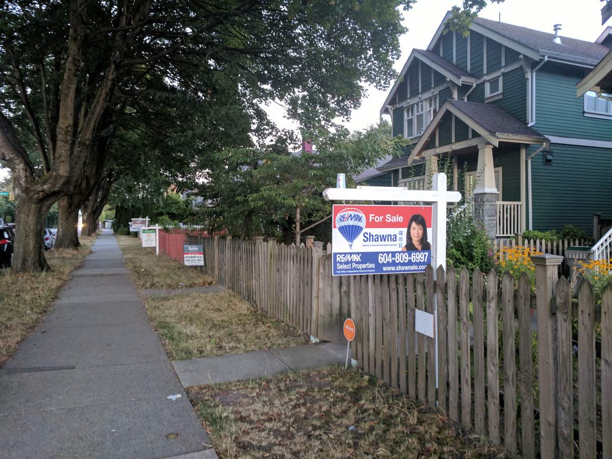For sale signs dot East Broadway in Vancouver. 