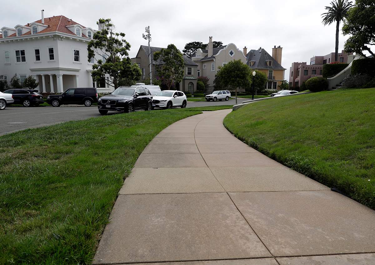 A sidewalk leads into luxury homes in the Presidio Terrace neighborhood, Monday, Aug. 7, 2017, in San Francisco.