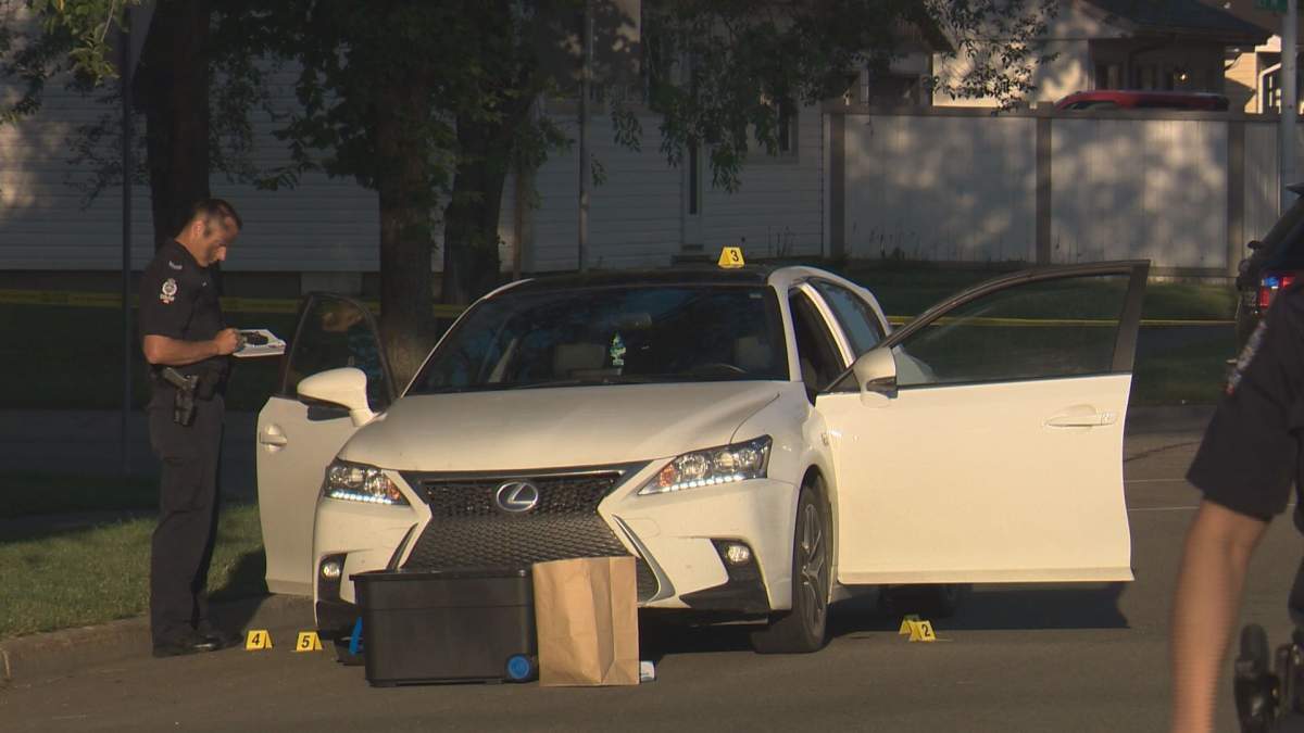 Officers gather evidence from a vehicle following a shooting Saturday night.