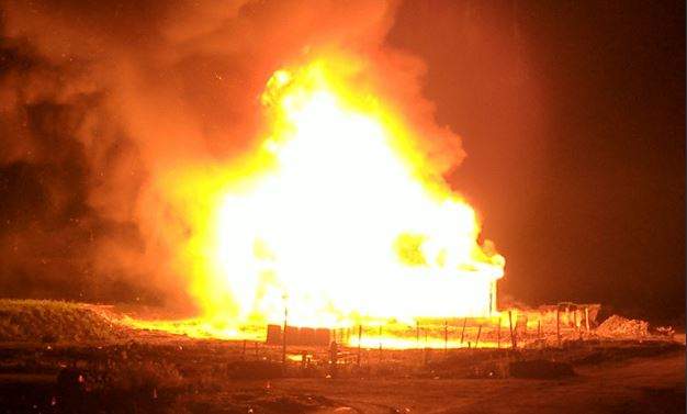 The unfinished homes were fully engulfed.
