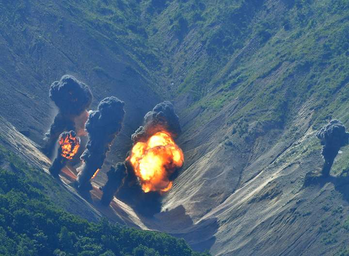 In this photo provided by South Korea Defence Ministry, bombs dropped by U.S. Air Force B-1B bombers, F-35 stealth fighter jets and South Korean F-15 fighter jets hit a simulated target as they fly over the Korean Peninsula, Thursday, Aug. 31, 2017.