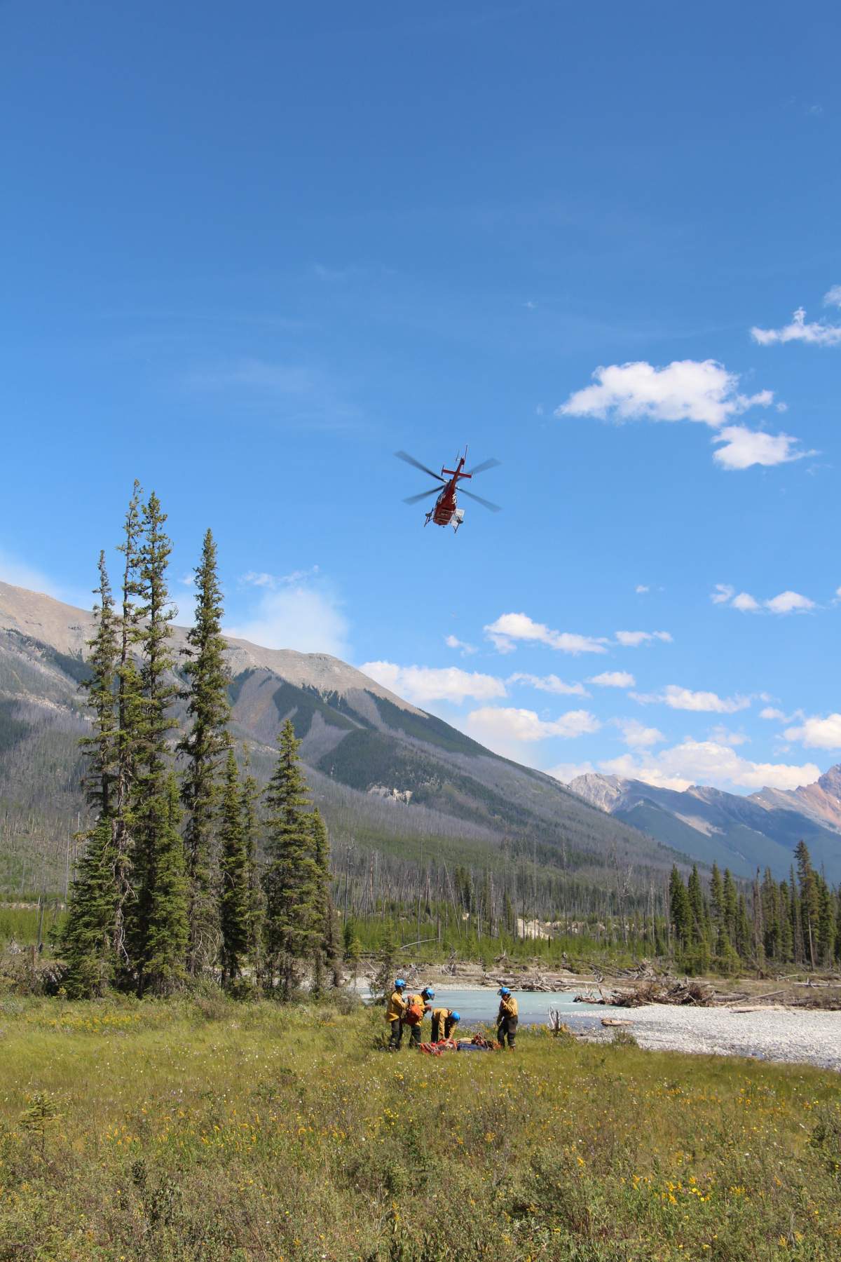 Parks Canada firefighters and a helicopter involved in battling a wildfire burning in the Verdant Creek area.