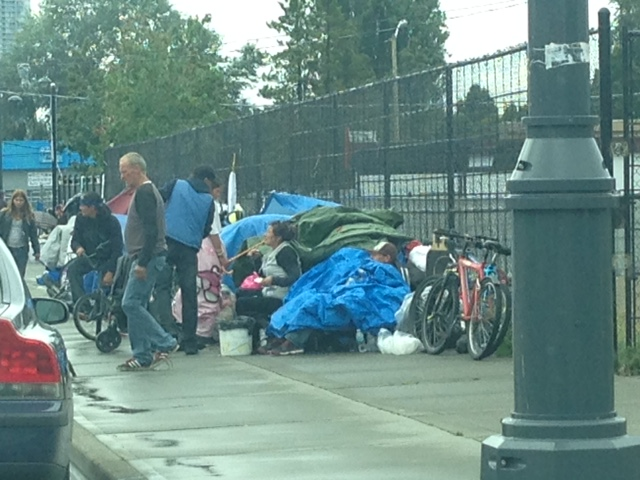 Homeless people gather on Whalley's so-called "strip," along 135 A Street in this photo taken on June 19, 2018.