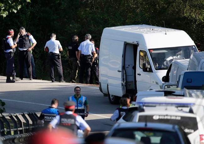Police bomb squad officers work by a road near Subirats, Spain, Monday, Aug. 21, 2017