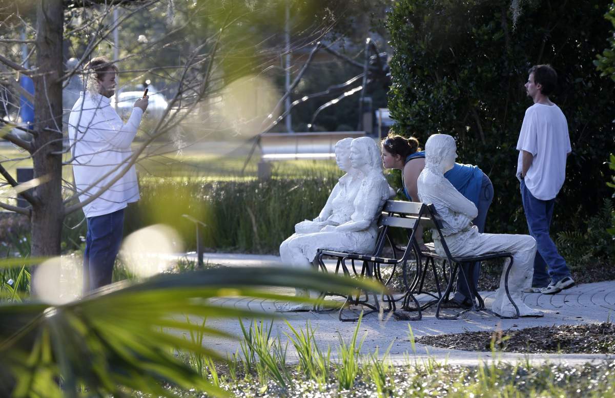 People take photos the Sydney Walda Besthoff Sculpture Garden in City Park in New Orleans, Tuesday, Jan. 15, 2013.  (AP Photo/Gerald Herbert)