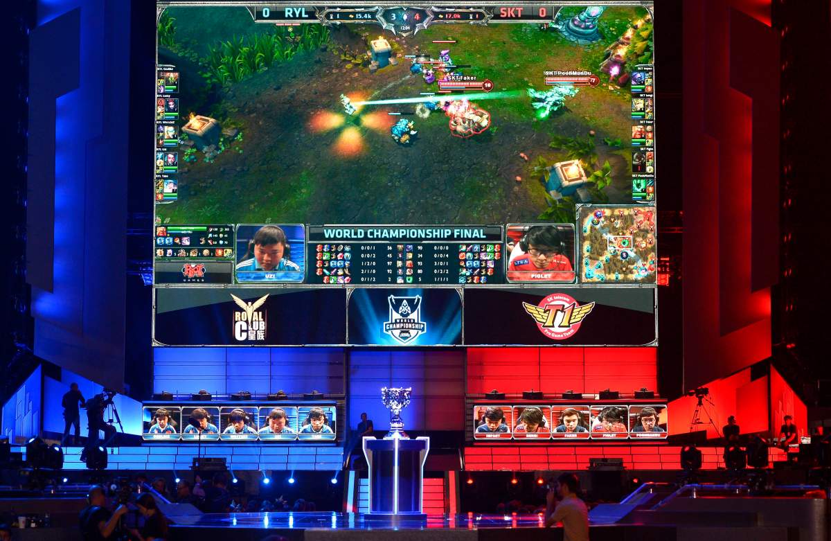 FILE - In this Oct. 4, 2013, file photo, the teams of China's Royal Club, left, and South Korea's SK Telecom T1 compete at the League of Legends Season 3 World Championship Final in Los Angeles. 
