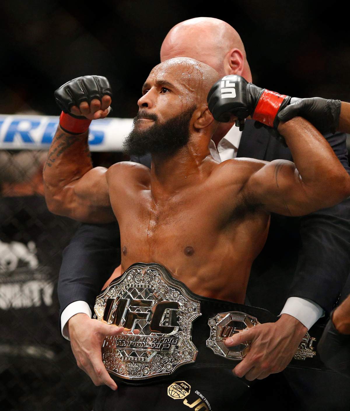 FILE – In this Sept. 5, 2015, file photo, Demetrious Johnson celebrates after defeating John Dodson in a flyweight title mixed martial arts bout at UFC 191 in Las Vegas.